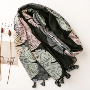 Artistic ginkgo leaf print scarf with fringe details and minimalist lifestyle aesthetic
