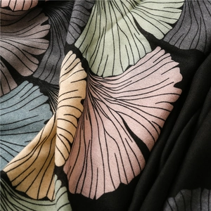 Detailed close-up of retro ginkgo leaf print on soft cotton-linen fringe scarf fabric