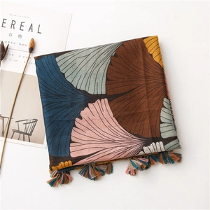 Close-up of vintage ginkgo leaf print cotton linen scarf with colorful tassel fringes