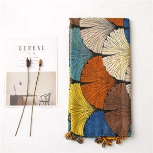 Artistic ginkgo leaf print scarf with colorful fringe tassels on white background