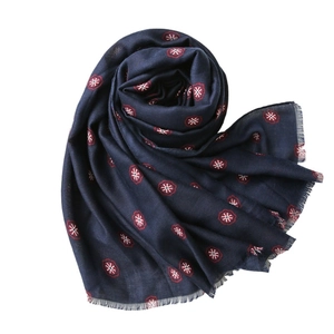 Bohemian navy cotton linen scarf with red floral prints and frayed edges on white background