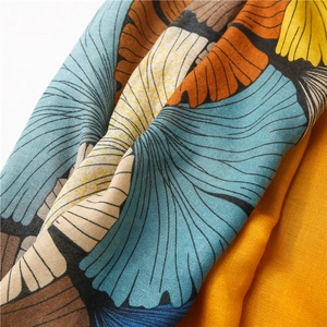 Macro detail of artistic ginkgo leaf print on soft linen-feel fabric scarf
