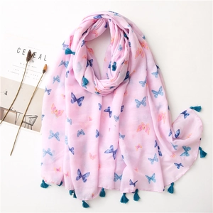 Close-up of pink butterfly print scarf with delicate dark blue tassels on white background