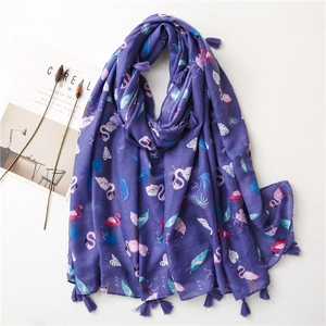 Detail of purple cotton linen scarf featuring pink flamingo prints and fringed edges