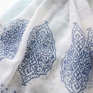 Close-up of lightweight floral scarf showing soft cotton-linen texture and blue paisley print