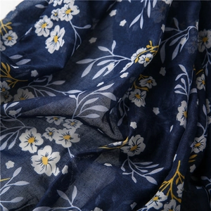 Close-up of bohemian navy blue cotton linen fabric with floral cashew nut pattern texture