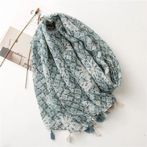 Blue geometric print lightweight scarf with tassel edges on a white background