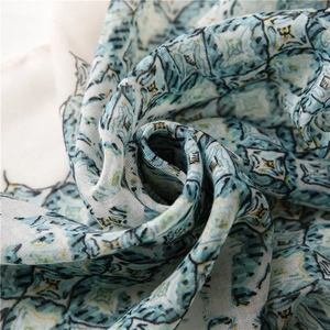 Macro shot of blue geometric floral print scarf showing delicate weave and soft texture