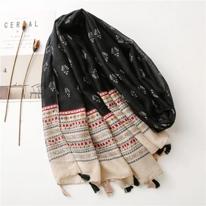 Artistic black and beige beach scarf with ethnic feather patterns and tassel details