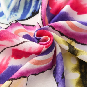 Macro shot of colorful leaf print cotton linen scarf showing soft fabric texture and weave