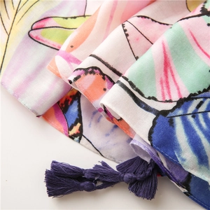 Close-up of colorful leaf pattern cotton linen scarf with purple tassel fringe detail