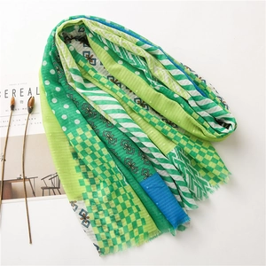 Green cotton linen scarf with mixed patterns of plaid and polka dots featuring tassels
