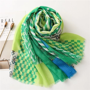 Detail of colorful plaid cotton linen scarf with frayed edges and geometric patterns