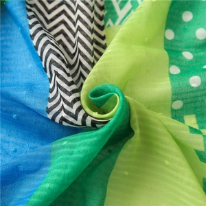 Detailed macro view showing the colorful checkered pattern and soft gauze texture of the scarf