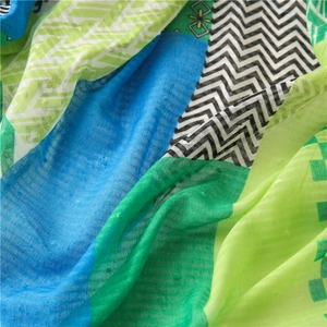 Macro detail of colorful plaid cotton linen scarf featuring dobby dots and zigzag patterns