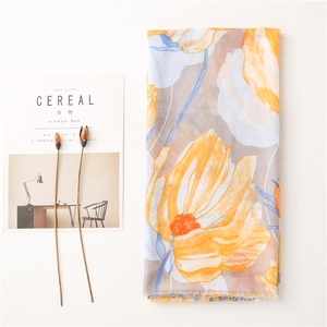 Detailed macro view of yellow floral print on breathable light cotton linen scarf