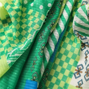 Detail showing the lightweight green checkered cotton linen fabric with dot texture
