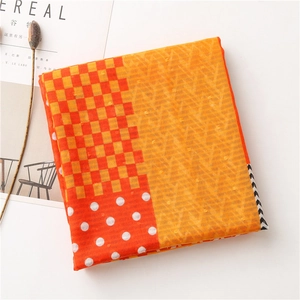 Detail of colorful plaid cotton linen scarf with geometric patterns and fringe edges