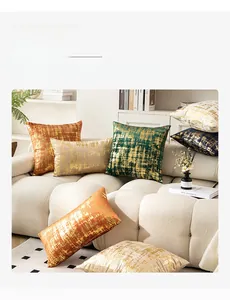Velvet cushion covers with gold foil textures in multiple colors and sizes on a sofa