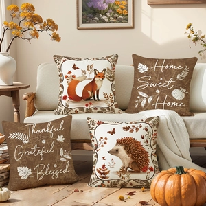 Set of four Thanksgiving pillow covers with fox, hedgehog and autumn quotes on sofa