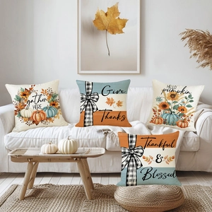 Set of four Thanksgiving pumpkin and sunflower cushion covers on a cozy white sofa