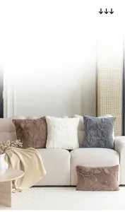 Detailed view of jacquard leaf patterns on plush cushions in coffee, white and blue
