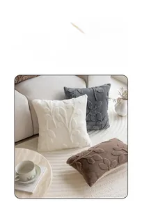 Detail showing plush jacquard texture and 3D leaf pattern on decorative sofa cushions