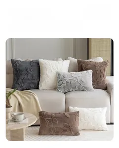 Detail of plush jacquard pillow covers with 3D leaf pattern texture in neutral colors