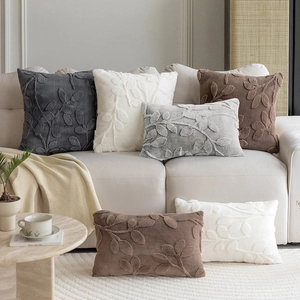 Plush jacquard throw pillow covers with 3D leaf pattern on a modern living room sofa