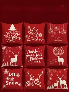 Detail view of nine red Christmas pillow covers with white reindeer and snowflake prints