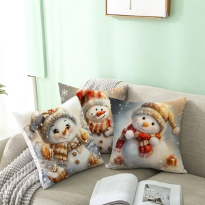 Three Christmas snowman throw pillow covers on a gray sofa for holiday home decor