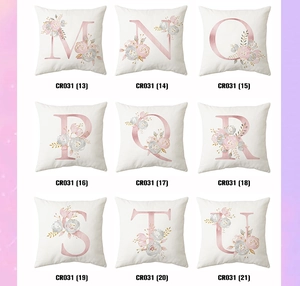 Detail view of nine white pillowcases featuring floral alphabet patterns from M to U