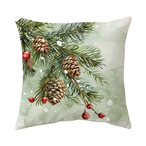 Winter Christmas pillow cover with pine branches, cones and red berries on white backdrop