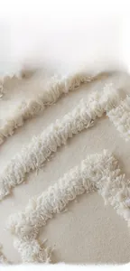 Macro shot of boho tufted beige pillow cover with geometric tassels and textured fabric
