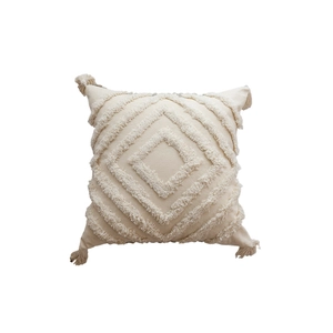 Bohemian off-white tufted pillow cover with geometric patterns and corner tassels