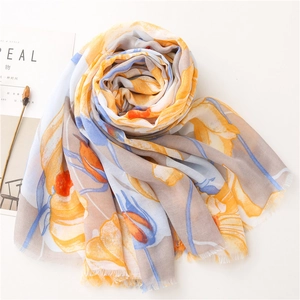 Close-up of lightweight floral linen scarf with vibrant prints and delicate frayed edges