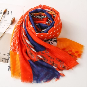 Detailed view of colorful checkered cotton linen scarf with soft fringe and geometric patterns