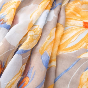 Close-up of lightweight linen cotton scarf showing yellow floral daisy print texture