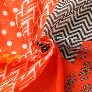 Macro shot of plaid cotton linen scarf showing orange patterns and textured weave detail