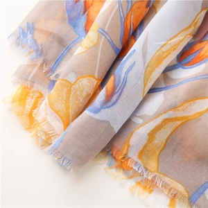 Detail of floral linen scarf showing soft watercolor prints and natural frayed edges