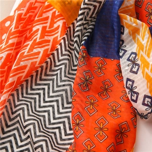 Detailed view of colorful geometric patchwork scarf with intricate jacquard dot texture