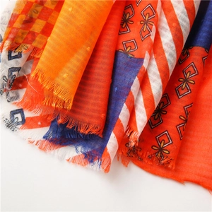 Detailed macro shot of a lightweight checkered linen scarf with colorful fringe edges
