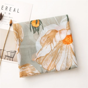 Detail of linen scarf with vintage daisy floral print and delicate fringed edges