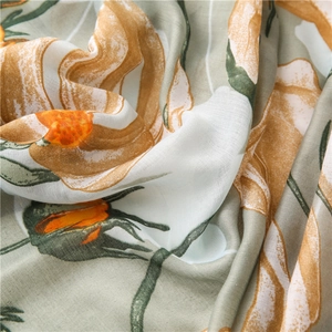 Close-up of semi-transparent linen cotton scarf with artistic floral pattern texture