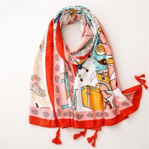 Detailed close-up of colorful elephant print cotton scarf with red tassels at the corners