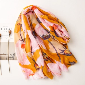 Detailed view of floral print linen scarf with delicate fringed edges and soft texture