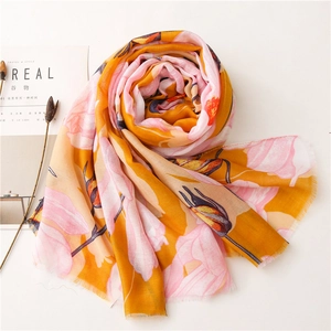 Detail of yellow and pink floral cotton linen scarf with soft frayed edges and tulip pattern