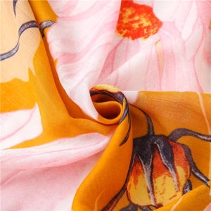 Detail of floral print on soft cotton linen scarf showing pink and yellow petals