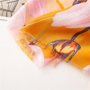 Close-up of lightweight floral cotton linen scarf with frayed edges and vibrant print