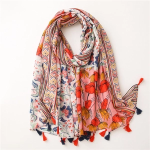 Close-up of cotton linen scarf with floral totem patterns and colorful fringe tassels